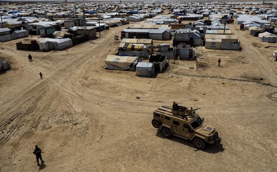 FILE - Kurdish forces patrol al-Hol camp, which houses families of members of the Islamic State group in Hasakeh province, Syria, on April 19, 2023. Iraq has repatriated hundreds more of its citizens linked to the Islamic State group from a sprawling camp in northeastern Syria, Iraqi and Syrian officials said Monday, April 29, 2024. (AP Photo/Baderkhan Ahmad, File)