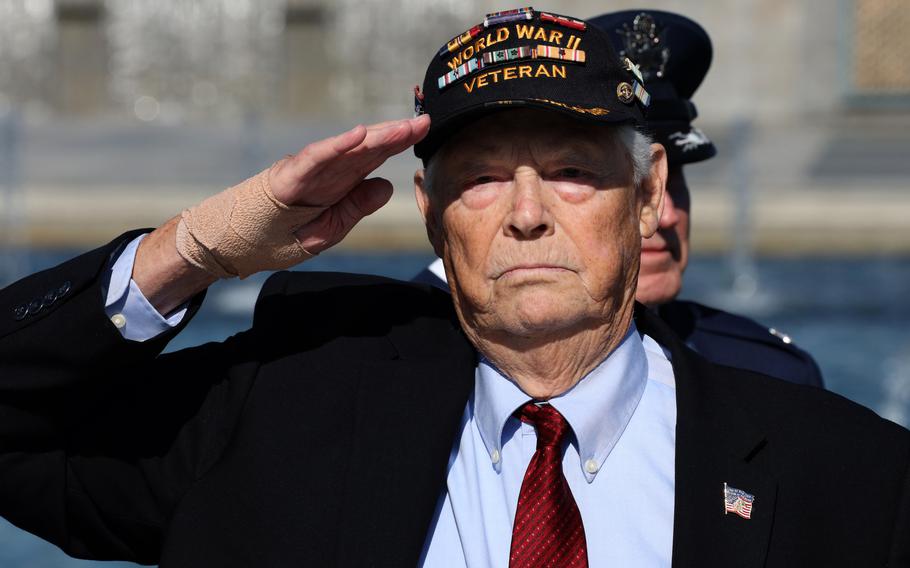 World War II veteran Les Jones salutes as the national anthem is played during a Memorial Day ceremony at the National World War II Memorial in Washington, D.C., May 31, 2021.