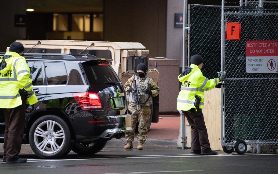 National Guard soldiers and Hennepin County Sheriff&apos;s deputies work security around the government center during jury selection in the trial of Derek Chauvin on March 23, 2021 in Minneapolis. 