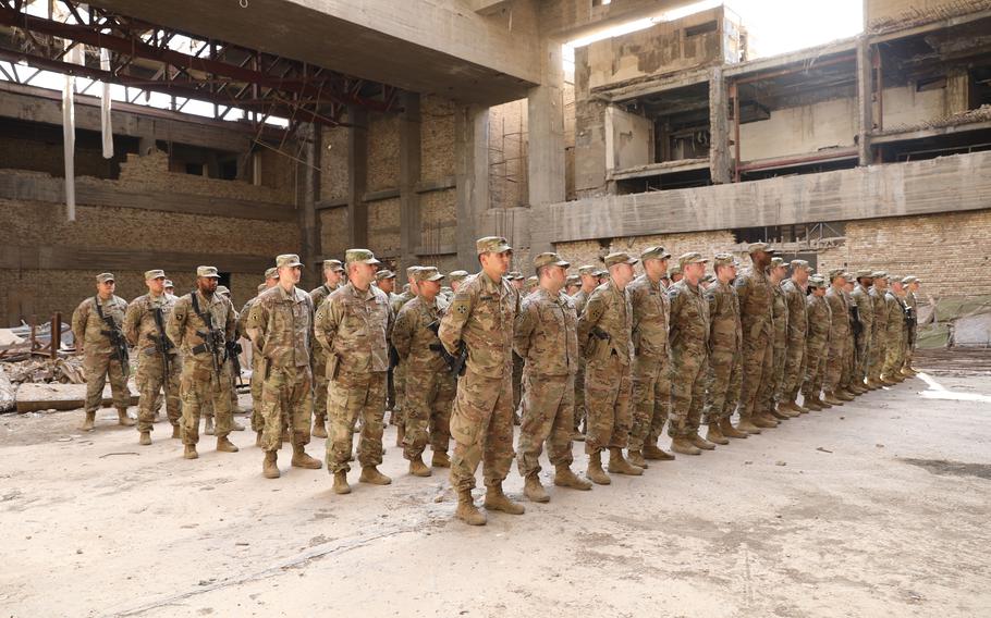 U.S. soldiers from the 299th Bridge Engineer Battalion and 4th Battalion, 9th Infantry, stand in formation during their Combat Action Badge Award ceremony in Baghdad, March 24, 2022. Several members of the Armys Task Force Pioneer were recognized for their actions the night of Dec. 19, 2021, when rockets targeted the coalitions facility in Baghdads Green Zone, known as Union III.