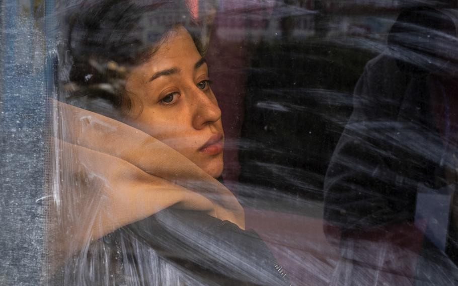 A woman waits aboard a bus in Mykolaiv, Ukraine, on April 5, 2022, to travel to the border with Moldova. Deadlier and more frequent Russian attacks on this southern Ukrainian city have many civilians fleeing in fear. 