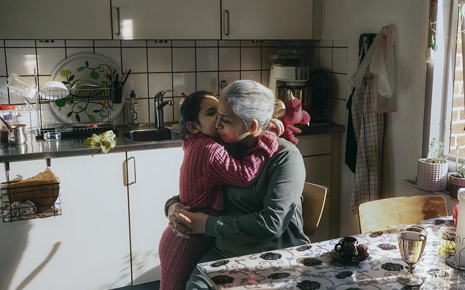 Yasmin Nasri hugs her daughter Lana before walking her to school in Jelling, Denmark. She fears deportation and separation from her husband and children. 