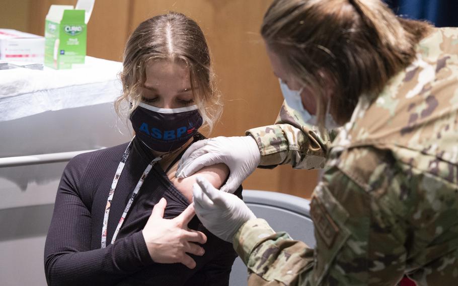 U.S. Air Force Capt. Erica Eyer, 88th Aerospace Operations Medical Clinic flight commander, gives Julia Cemberci, 88th Medical Group lab technician, her COVID-19 vaccine shot inside the Medical Center at Wright-Patterson Air Force Base, Jan. 5, 2021. 