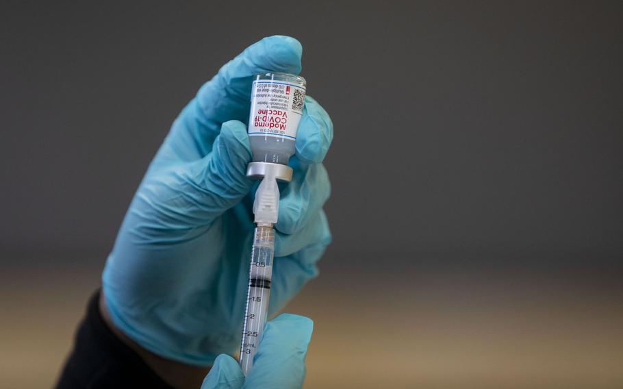 A syringe of the Moderna COVID-19 vaccine is prepared Feb. 14, 2021, at Steinmetz High School in Chicago.