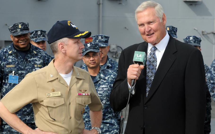 NBA Hall-of-Famer Jerry West interviews Capt. Thom Burke, commanding officer of the aircraft carrier USS Ronald Reagan, on Jan. 11, 2011, during a filmed segment on the flight deck of the Reagan as part of “Play for L.A.” an 18-day charitable event leading to the Northern Trust Open on Feb. 15. 