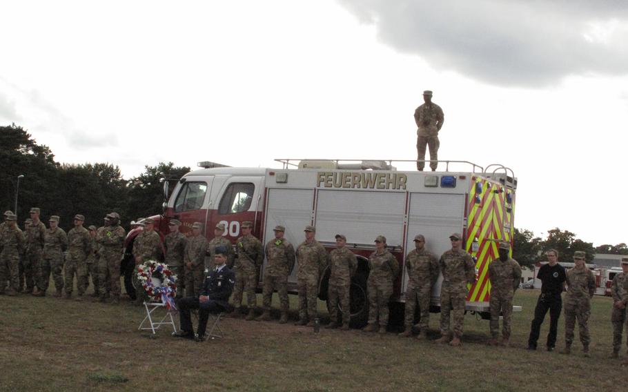 First responders listen to Maj. Gen. Randall Reed at a ceremony at Ramstein Air Base, Germany, on Sept. 10, 2021, to mark the 20th anniversary of 9/11.