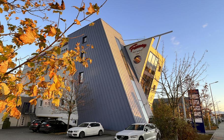 The stylish exterior of the office building in Ruesselsheim, Germany, that houses Freeway Restaurant hides the bright neon of its interior. This surprise destination invites patrons to enjoy a blend of American and German cuisines.