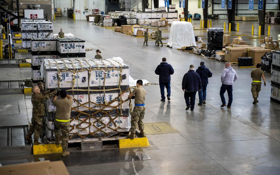 Airmen load military equipment onto pallets bound for Ukraine at Dover Air Force Base, Del., on March 8, 2022. 
