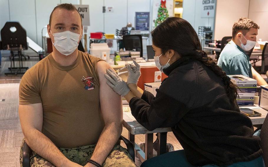 Seaman Apprentice Abigail Garcia administers the COVID-19 vaccination to Petty Officer 1st Class Jesse Sharpe at Walter Reed National Military Medical Center in Bethesda, Md., on Dec. 22, 2022. Many clinics at U.S. bases in Europe have yet to receive the latest vaccine.
