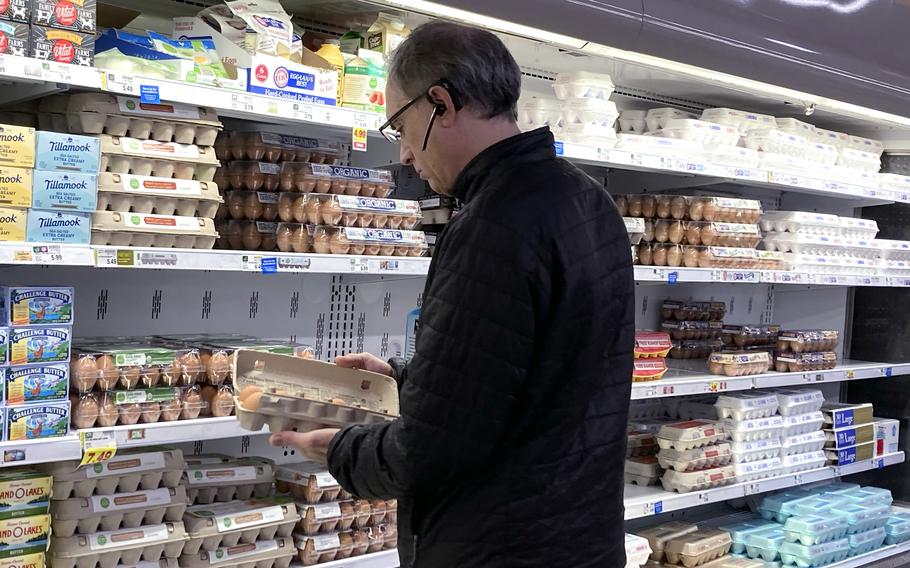 A shopper checks the eggs. 