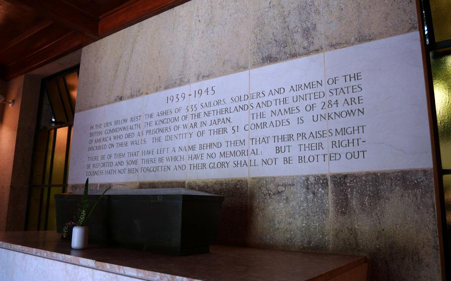 A memorial to service members is carved into marble at a cemetery in Japan.