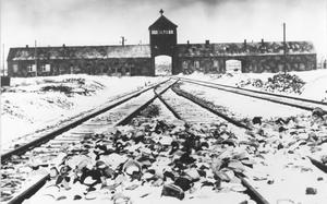 FILE- This February/March 1945, file photo shows the entry to the concentration camp Auschwitz-Birkenau in Poland, with snow covered rail tracks leading to the camp. Israel is hoping the U.N. General Assembly will unanimously adopt a resolution rejecting and condemning any denial of the Holocaust and urging all nations and social media companies “to take active measures to combat antisemitism and Holocaust denial or distortion.” The 193-member world body is scheduled to vote Thursday, Jan. 20, 2022, on the resolution, which is strongly supported by Germany. (AP Photo/Stanislaw Mucha, File)
