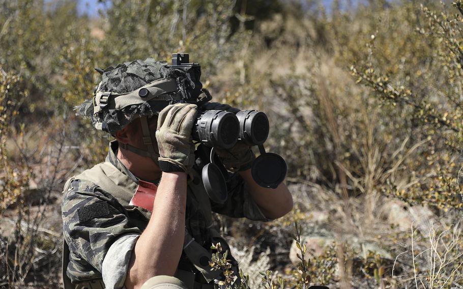 Sgt. Collier Montgomery, a Cavalry Scout from the 3rd Squadron, 61st Cavalry Regiment, 2nd Stryker Brigade Combat Team, Fourth Infantry Division uses binoculars to conduct surveillance on an enemy formation during a training exercise, October 14th, 2022 at Fort Carson, Colorado.