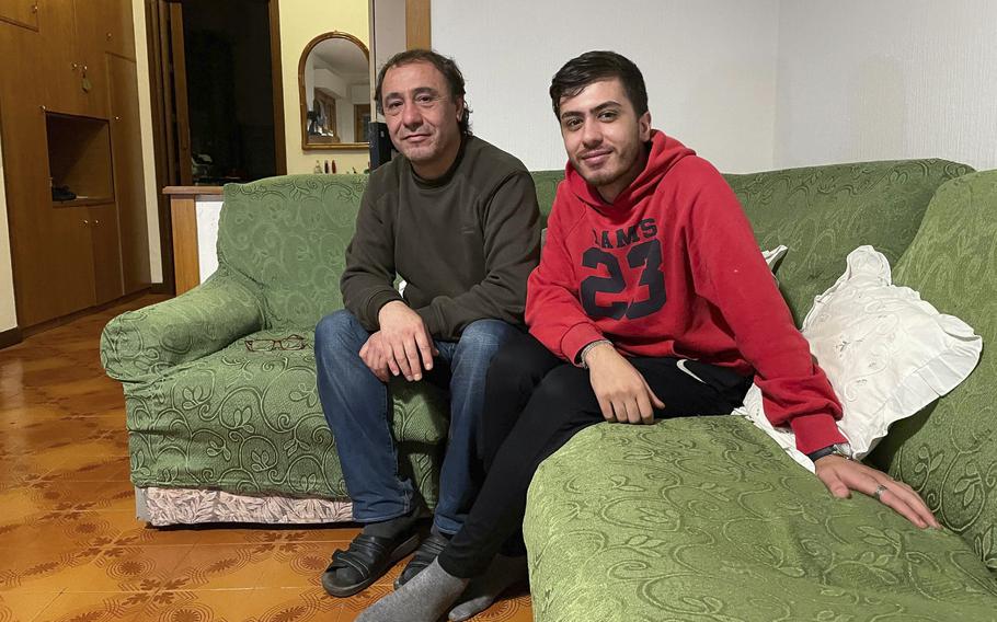 Ahmad Ramy Alshakarji and his son Majid are seen at their home in Rome on Dec. 3, 2021. 