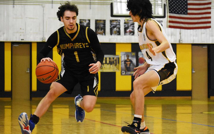 Humphreys' Tate Loyed dribbles against ASIJ''s Sid Abelson. The Mustangs won the quarterfinal 61-48.