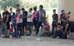 Migrants who crossed into the U.S. from Mexico wait to be processed by U.S. Border Patrol agents, Thursday, Sept. 21, 2023, in Eagle Pass, Texas. (AP Photo/Eric Gay)