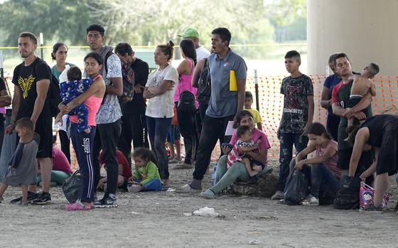 Migrants who crossed into the U.S. from Mexico wait to be processed by U.S. Border Patrol agents, Thursday, Sept. 21, 2023, in Eagle Pass, Texas. (AP Photo/Eric Gay)