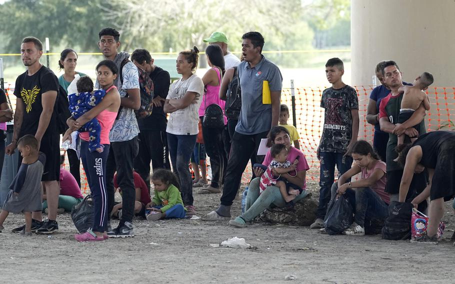 Migrants who crossed into the U.S. from Mexico wait to be processed by U.S. Border Patrol agents, Thursday, Sept. 21, 2023, in Eagle Pass, Texas. 
