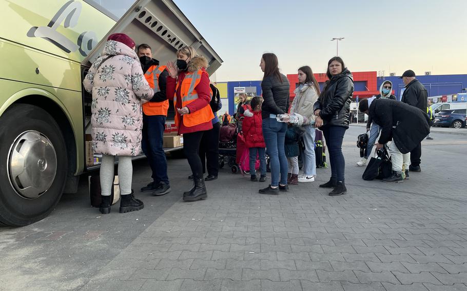 Outside a main refugee center in Przemysl, Poland, refugees await a bus en route to Italy. 