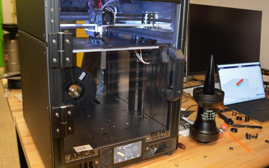 A 3D printer, roughly the size of a minifridge, fabricates a part made of polymer at Marine Corps Base Hawaii on July 2, 2024.