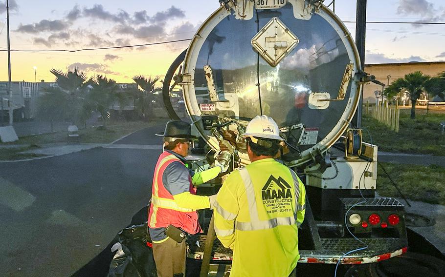 Workers with Joint Task Force-Red Hill disconnect a fuel line from a truck used for moving the final gallons of accessible residual fuel from the Red Hill Bulk Fuel Storage Facility in Hawaii on March 6, 2024.