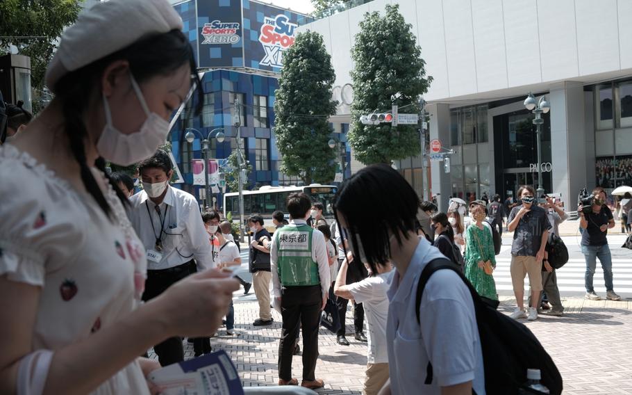 Residents wait in line at a walk-in COVID-19 vaccination site, targeting people in the 16-39 age group, in the Shibuya district of Tokyo on Aug. 27, 2021. 