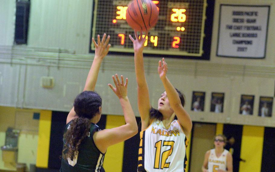 Kadena's Kaitlyn Wetherington shoots against Kubasaki's Amaya Schaffeld during Friday's DODEA-Okinawa girls basketball game. The Panthers won 44-40, leveling the season series at 1-1.