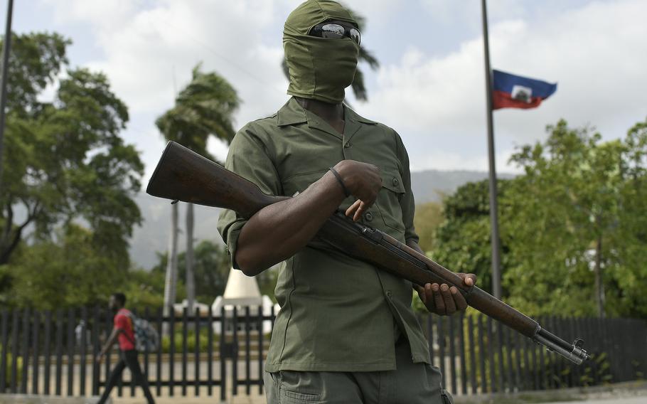A security guard stands outside the National Pantheon Museum before a ceremony in honor of late Haitian President Jovenel Moise in Port-au-Prince, Haiti, Tuesday, July 20, 2021.