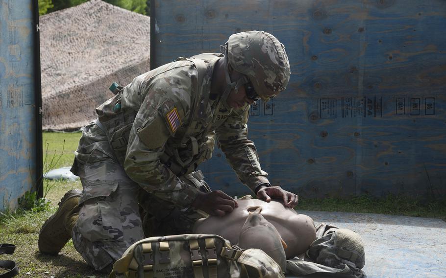 Sgt. Lloyd Shepherd, a member of the U.S. Army Japan Band, performs first aid on a simulated casualty during the Expert Soldier Badge evaluation, April 26, 2024, at Sagami General Depot, Japan.