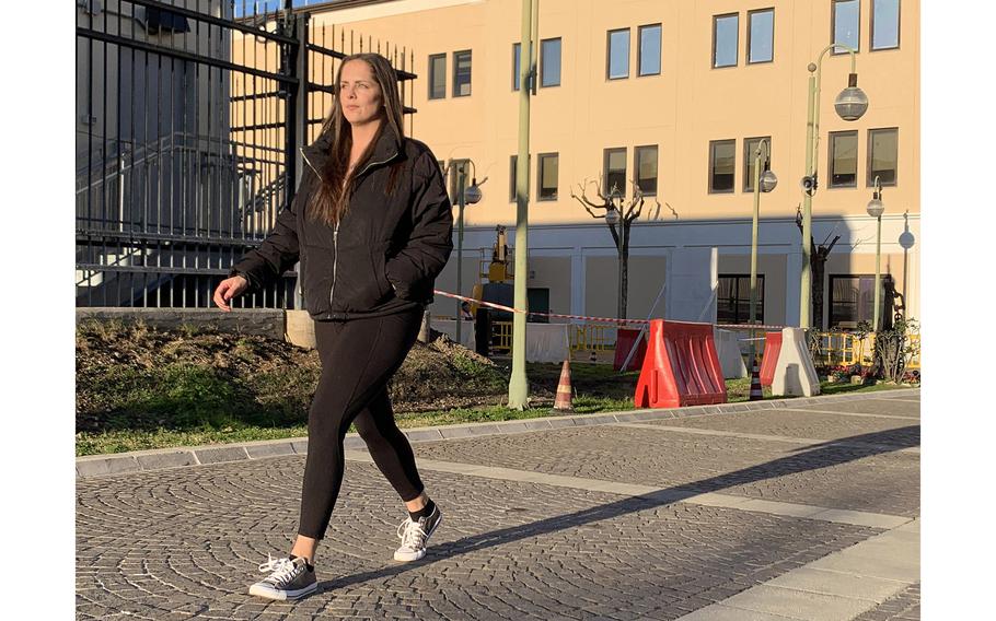 Navy Petty Officer 1st Class Caroline Crumbacker walks at Naval Support Activity Naples, Italy, on Jan. 12, 2022. Crumbacker, who refused the COVID-19 vaccine, said that despite a recent Defense Department reversal of the vaccine mandate, she is undecided about staying in the Navy past her enlistment end date. 