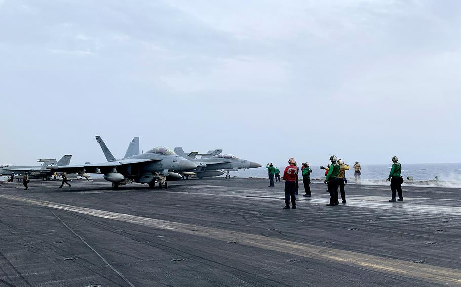 Flight deck crew members ready an EA-18G Growler electronic warfare plane for launch from the aircraft carrier USS Dwight D. Eisenhower on March 19, 2024. 