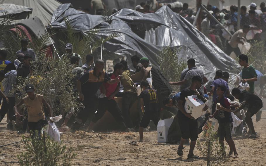 Palestinians running to get humanitarian aid.