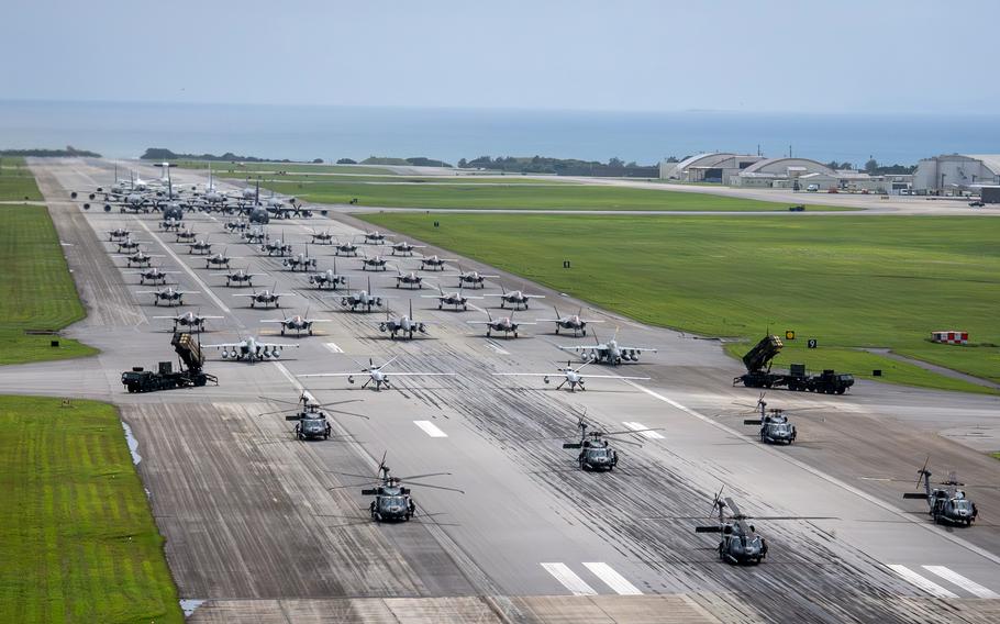 Aircraft line up on a runway at Kadena Air Base.
