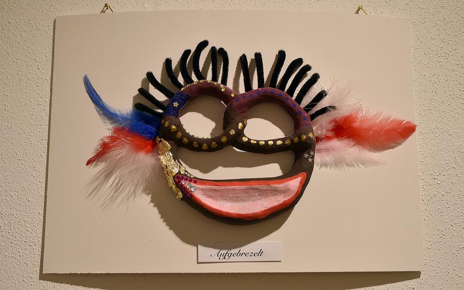 A pretzel made to look like a face mask as art.