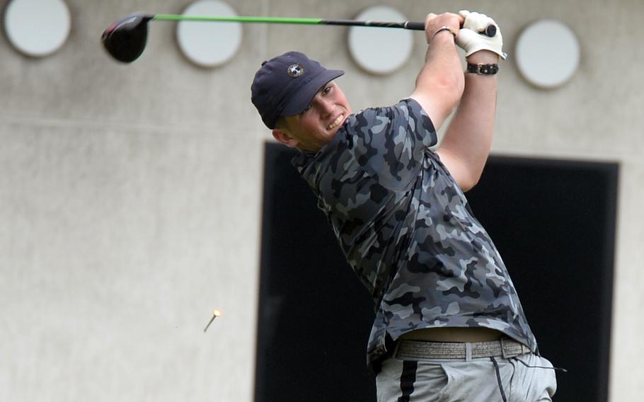 Matt Burn swings a golf club.