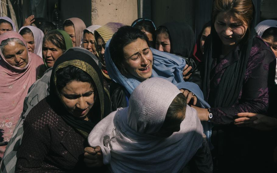 Family members attend a funeral in May for Niazi, an Afghan National Army soldier who was killed after his outpost was surrounded by the Taliban. 