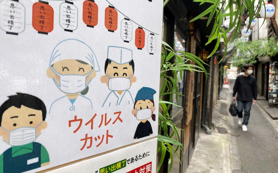 A sign informs customers that workers are taking coronavirus precautions at Omoide Yokocho, an alleyway lined with food stalls in Shinjuku, Tokyo, Sunday, June 13, 2021. 