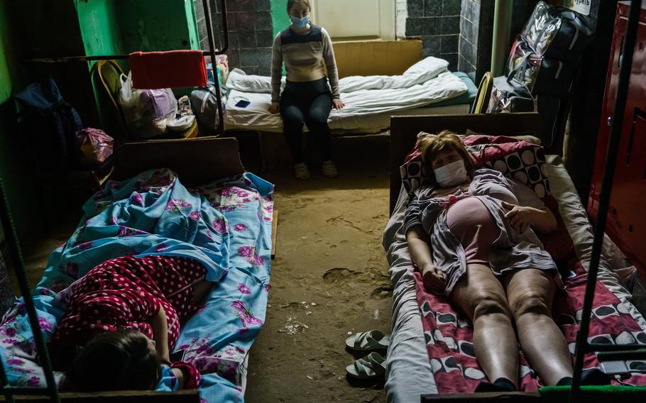 Marina Astafieva, top, in a shelter after a maternity ward moved its patients underground a safer place because its exterior had been bombarded, in Kharkiv, Ukraine, on March 25, 2022.