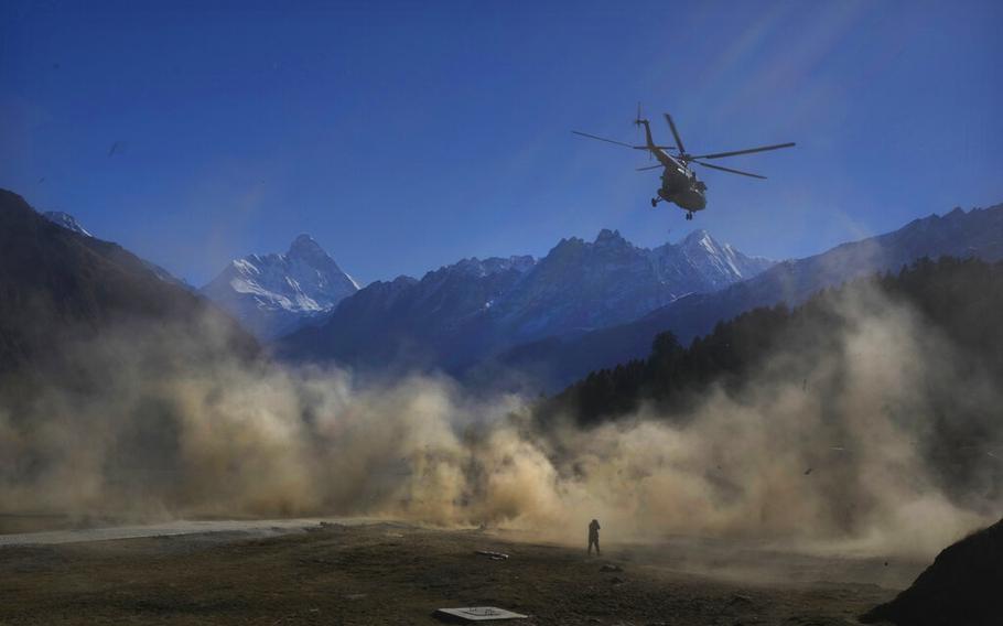 A helicopter carrying Indian army soldiers  takes off during Indo-US joint exercise in Auli, in the Indian state of Uttarakhand, Tuesday, Nov. 29, 2022.  