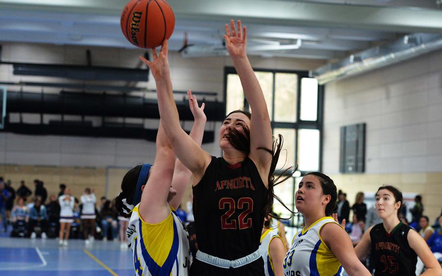 AFNORTH’s Paula Bohlen goes to the basket between Sigonella’s Laney Reardon, left, and Leila Denton in the Division III championship game at the DODEA-Europe basketball finals in Ramstein, Germany, Feb. 18, 2023. Sigonella took the title with a 36-25 win.