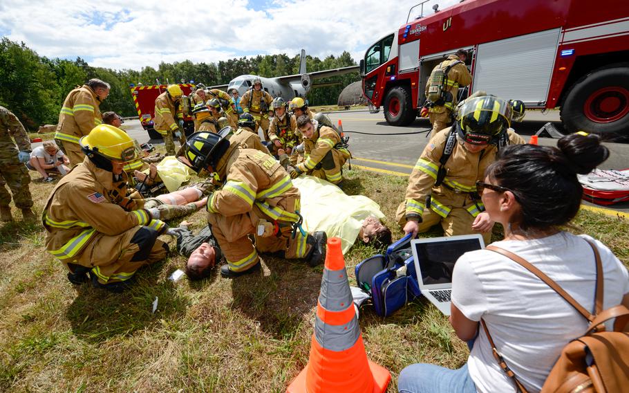 Firefighters and security forces patrolmen tend to victim actors and training mannequins during a simulated aircraft crash scenario at Ramstein Air Base, Germany, July 26, 2022. The base-wide exercise Operation Varsity tested the 86th Airlift Wing’s ability to respond to major emergencies including a fictional tornado and a simulated aircraft crash.