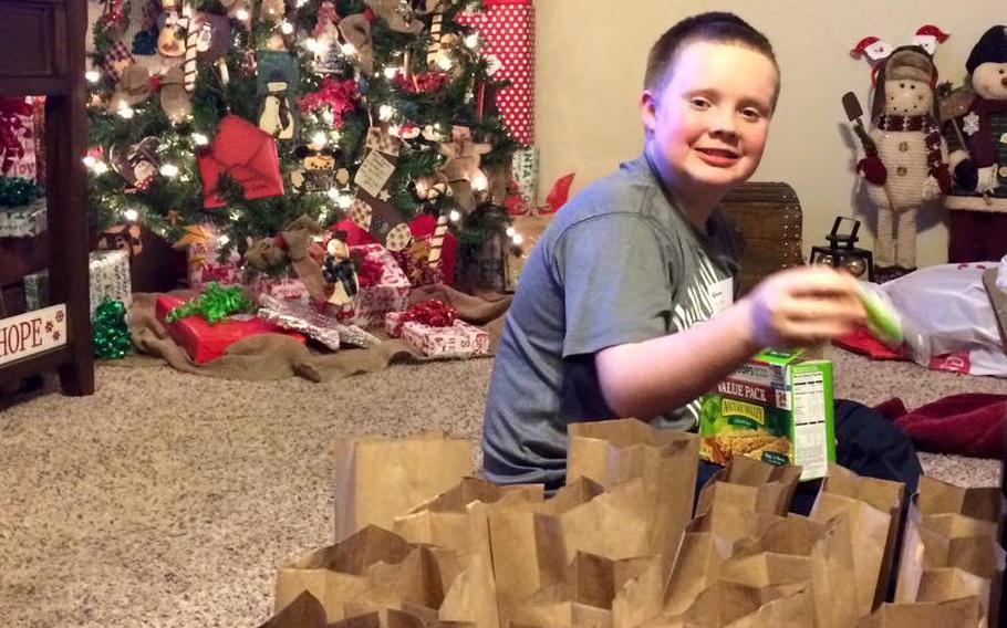 Reed Marcum put together treat bags to give away with the toys at his first holiday giveaway when he was 11.