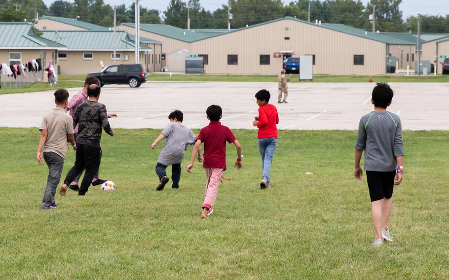 Afghan evacuees play soccer together Saturday, Sept. 4, 2021, at Camp Atterbury, Ind. The division soldiers along with Indiana National Guard soldiers will provide transportation, temporary housing, medical screening and logistics support as part of Operation Allies Welcome.