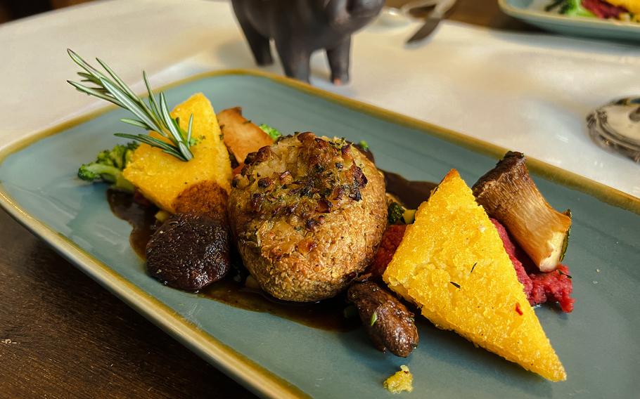 A vegan golden flaxseed and lentil fritter is served alongside polenta and homegrown shiitake and herb mushrooms, with a savory vegetable jus at "The Weinstube," at Hotel Nicolay 1881  in Zeltingen-Rachtig, Germany, March 2, 2022. The dish was served as part of a three-course chef's choice menu.