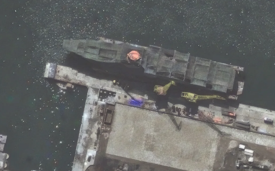A top view of a warship being built in the water