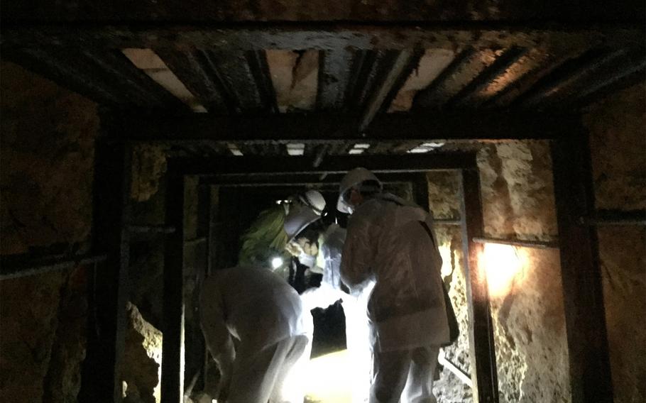 Okinawa government officials inspect the underground headquarters of Imperial Japan's 32nd Army in Naha, Okinawa, Jan. 22, 2021.