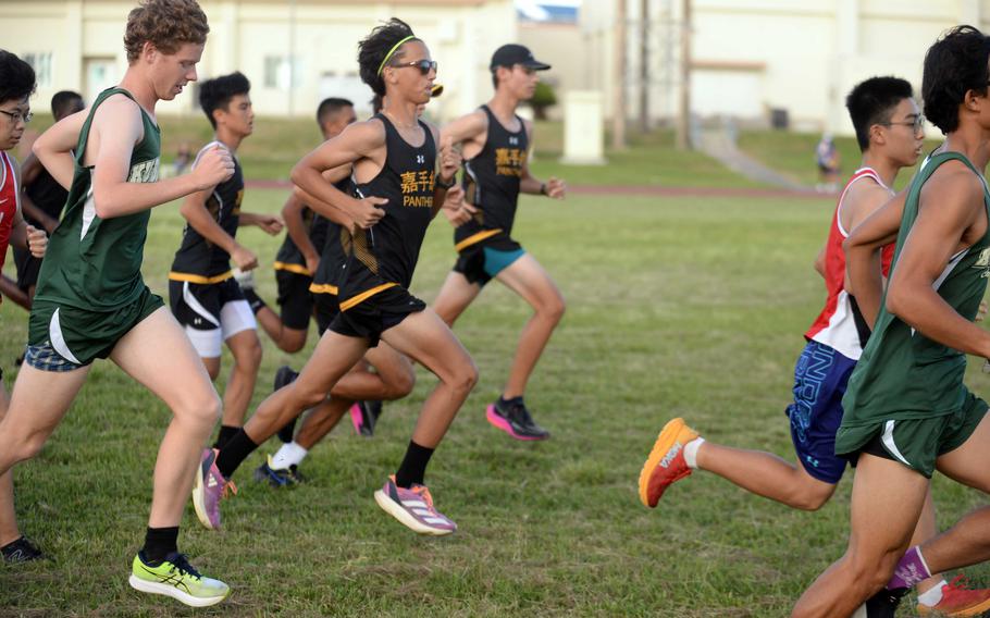 Kadena's Sebastian Praske, in sunglasses, takes off at the start of Wednesday's Okinawa cross-country race. Praske, a senior transfer from North Carolina, won the race in 17 minutes, 17.2 seconds.