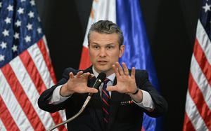 U.S. Secretary of Defense Pete Hegseth gestures during a joint press conference with Philippines' Secretary of National Defense Gilberto Teodoro after their meeting at Camp Aguinaldo in Manila on March 28, 2025. U.S. defense chief Pete Hegseth met Philippine President Ferdinand Marcos on March 28, saying the two countries must stand "shoulder to shoulder" in the face of the threat represented by China. Hegseth is expected to give a speech Saturday as military leaders including high-level representatives from China meet in Singapore starting Friday for the Shangri-La Dialogue.  (Ted Aljibe/AFP via Getty Images/TNS)