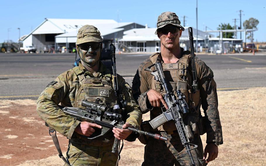 A U.S. Marine and an Austrailian soldier.