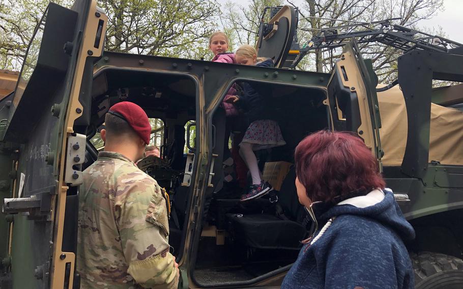 Children get inside a military vehicle during a community festival hosted by the U.S. Army Garrison in Stuttgart on May 1, 2023.
